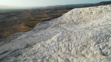 aerial view of pamukkale, turkey, white travertine hills and landscape, drone shot