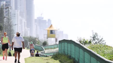 people walking and jogging on a coastal path