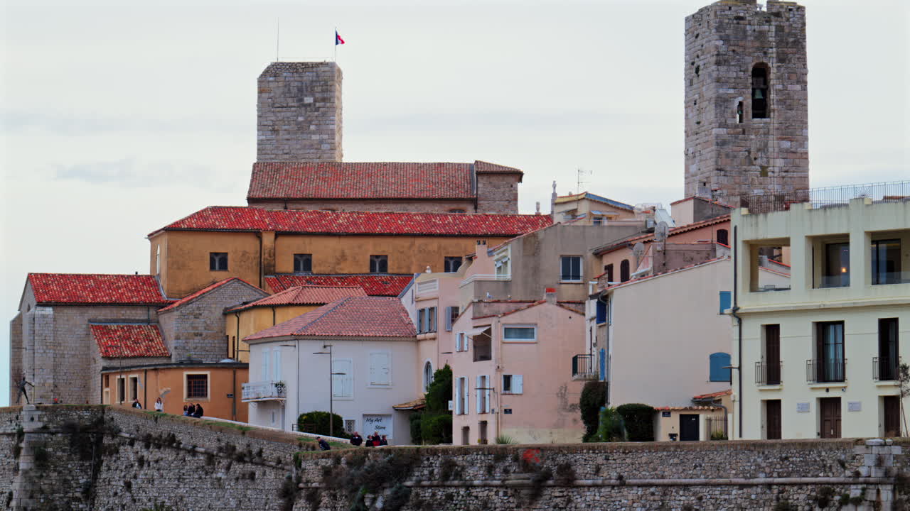 Antibes, France - February 20, 2025: View of people walking near different buildings on the coast