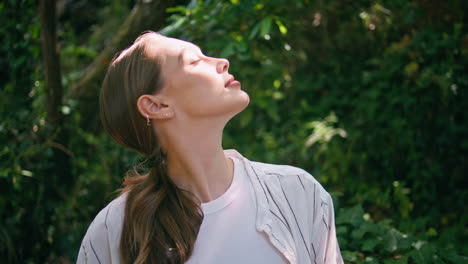 tranquil woman enjoy sunlight sitting green forest close up. lady relaxing park