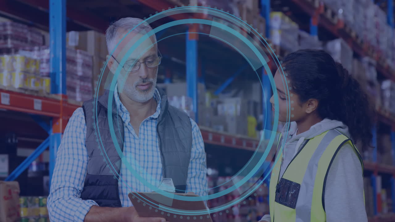 In warehouse, workers discussing logistics with digital data protection overlay animation