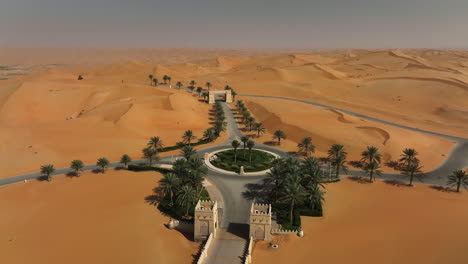 aerial view over a roundabout and a road in middle of the desert in sunny middle uae