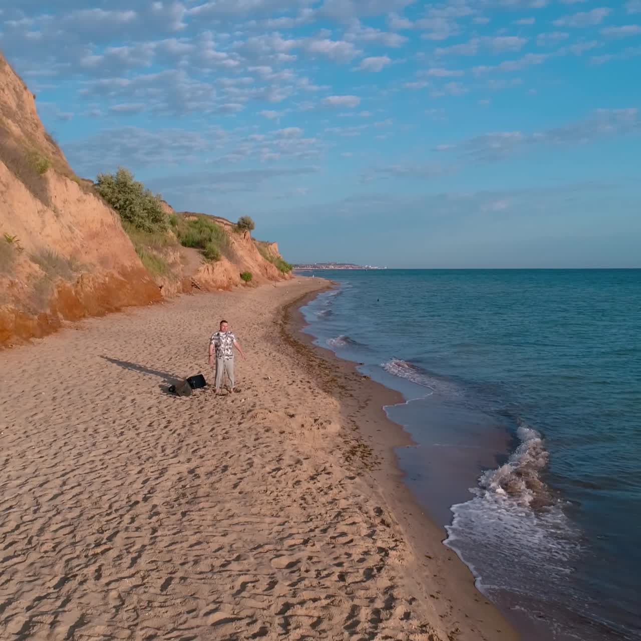 Talented Man Sing Song Into Microphone. Aerial view of man singing song at concert on the beach