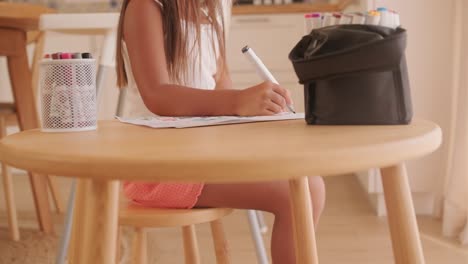 Child drawing at table