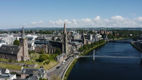 drone shot pulling away from the free church of scotland to reveal the surrounding city of inverness