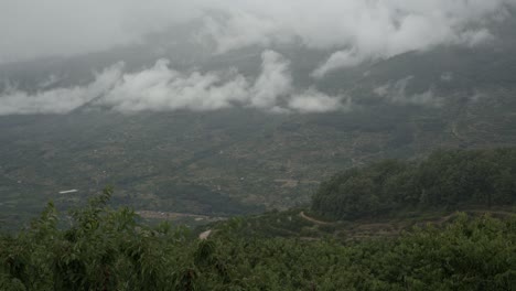 timelapse of the jerte valley with fog disappearing and clouds forming over the cherry terraces, spain agriculture