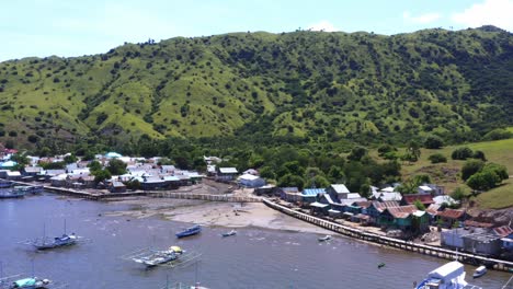 fleet of motorised pinisi fishing boats moored of a coastal fishing village