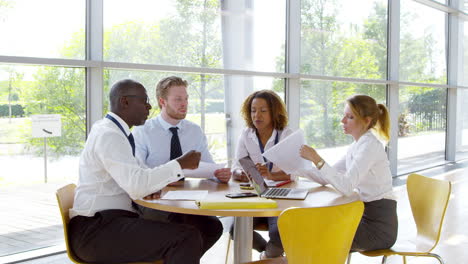 business team having meeting around table in modern office