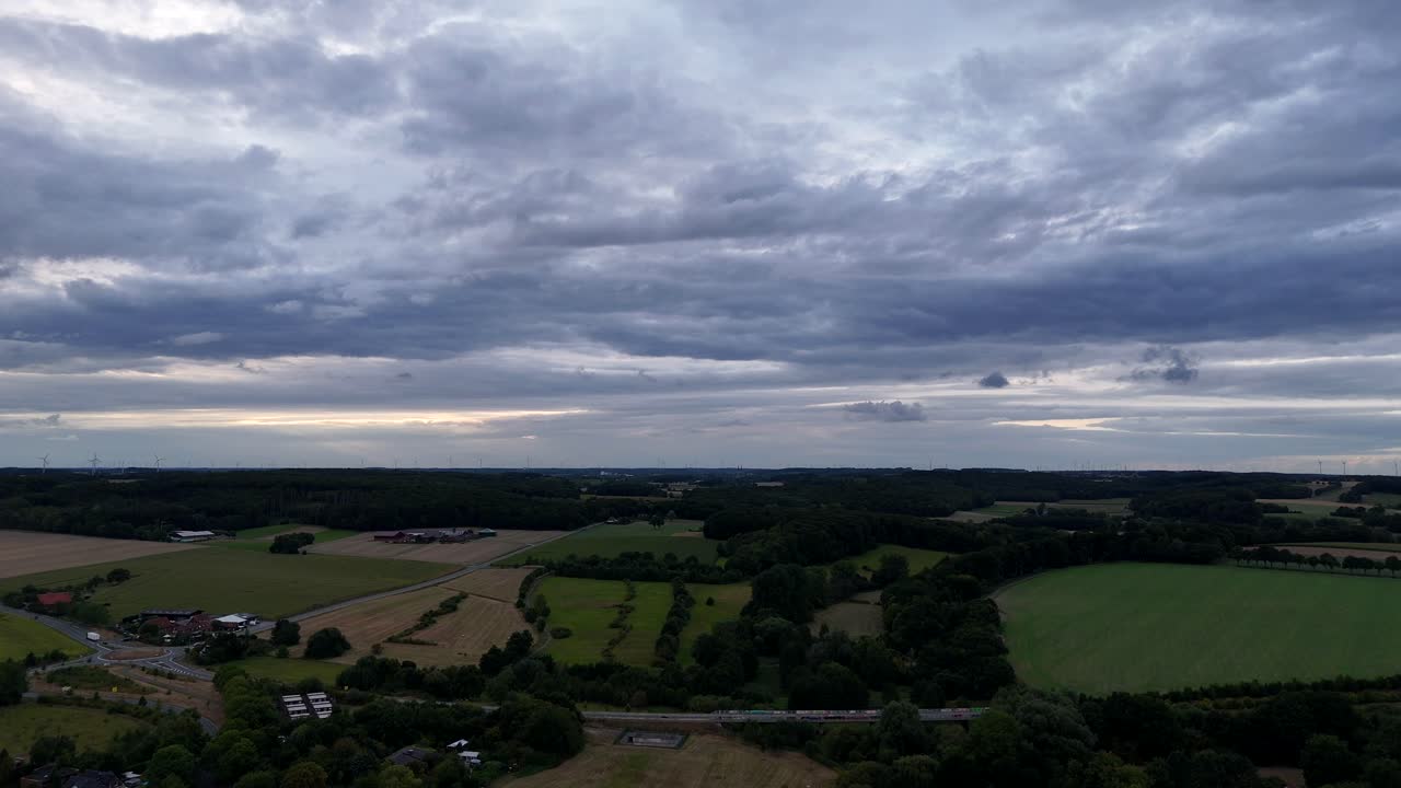 American countryside fields and hills in small village town of USA. Aerial wide shot. Panorama view. Intersection and roundabout on cloudy day. Sunrise in the morning