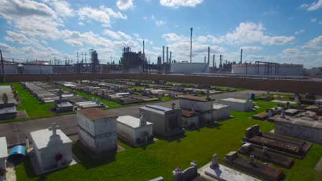 an aerial over a louisiana cemetery reveals a huge chemical factory refinery in the distance 2