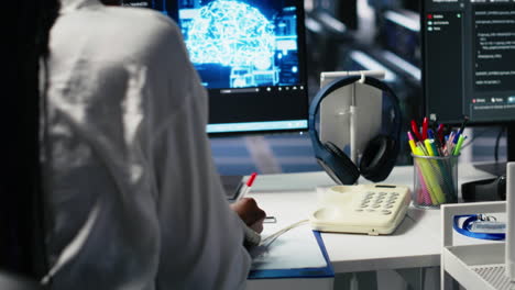 female technician in data center answers telephone call, assisting users with ai
