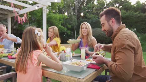 three generation family enjoying lunch outdoors