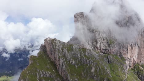 aerial view of mountain peaks above seceda ridge in italian dolomites, descending