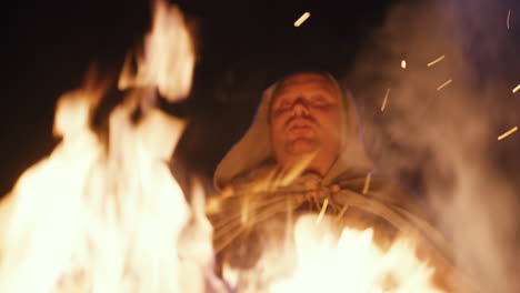 mystical figure by the fire