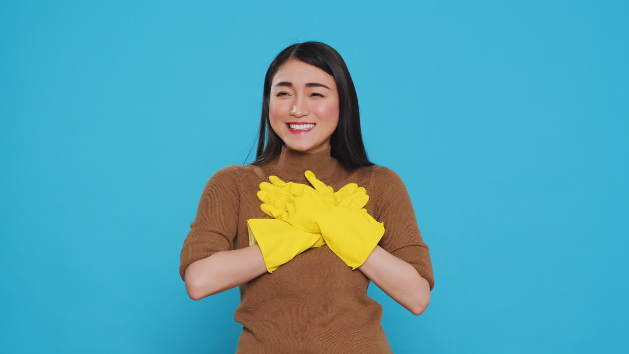 Happy asian maid being happy about finishing house cleaning