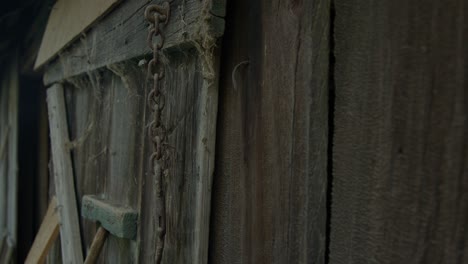 a detailed close-up shot of an old weathered wooden shed wall evokes a rustic, abandoned, and nostalgic atmosphere
