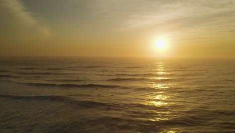 Aerial-view-of-sunrise-horizon-over-the-rolling-sea-waves