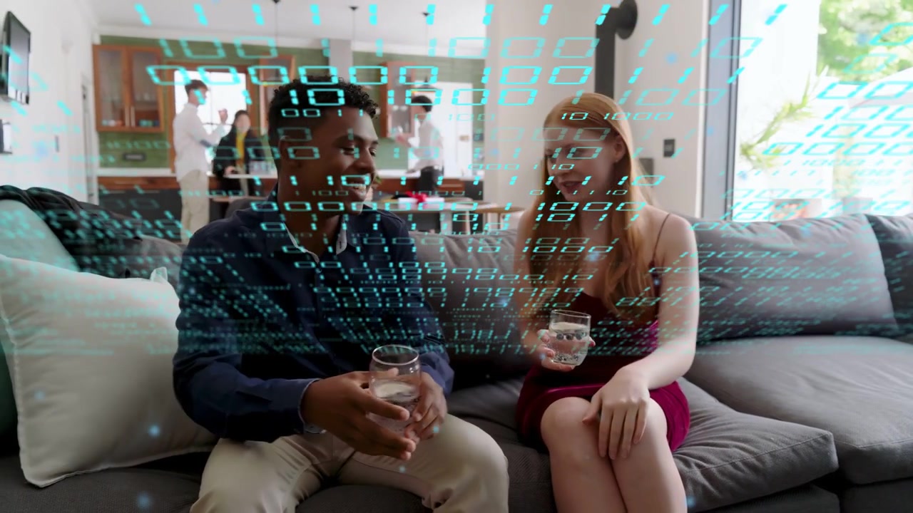 Man carrying glass toward woman at party, offering drink, leaning, chatting under binary overlay