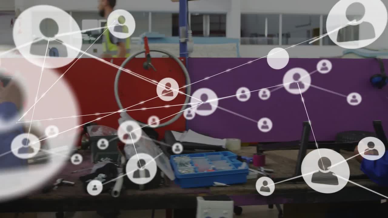 Techs grabbing parts and building wheel frame as net overlay growing over workers for assembly