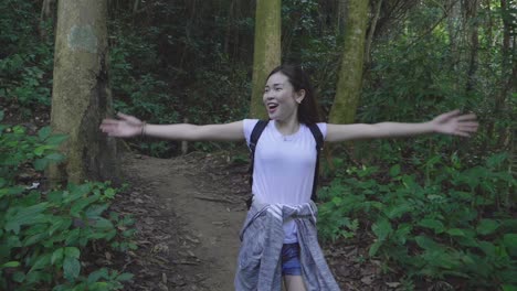 tourist woman walking and enjoying at forest trail, slow motion