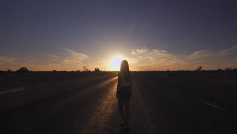 rear zoom in shot of woman silhouette enjoying beautiful sunset at 90 mile straight