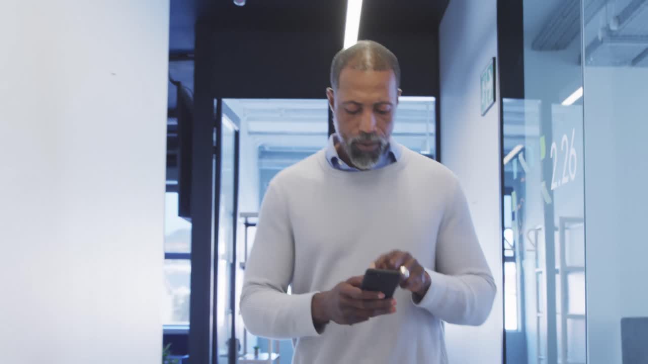 Businessman using smartphone in modern office