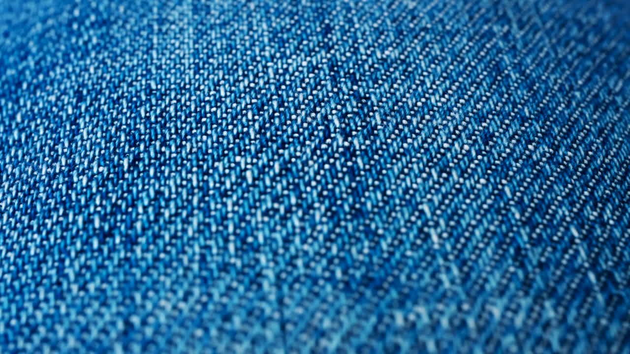 Close up of blue denim fabric texture showing fine threads and detailed textile pattern