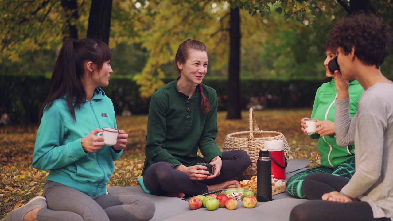 Friends enjoying a autumn picnic in the park