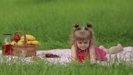 Weekend-at-picnic.-Girl-on-grass-meadow-play-online-games-on-mobile-phone.-Social-network,-chatting