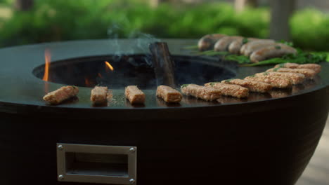 minced meat sticks grilling on grill outside. meat kebab frying on grid