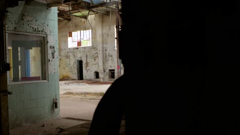 a pan from right to left from the perspective of the doorway of an abandoned factory