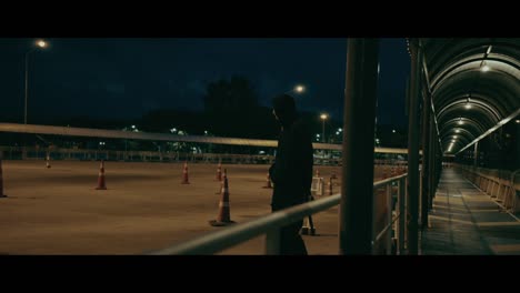 person walking at night in a parking garage