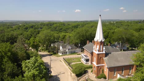 aerial view of small town usa and classic church with white steeple