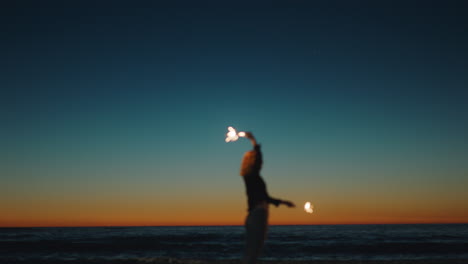 girl dancing with sparklers on beach at sunset celebrating new years eve woman having fun dance with sparkler fireworks enjoying independence day celebration by the sea