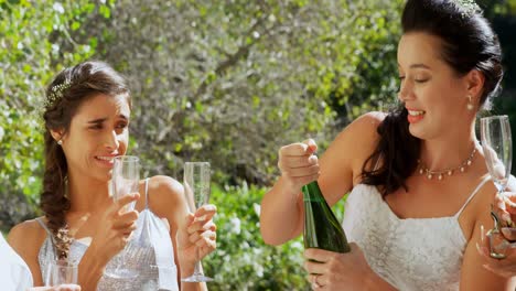 happy bride open champagne bottle and bridesmaid waiting for  champagne4k 4k