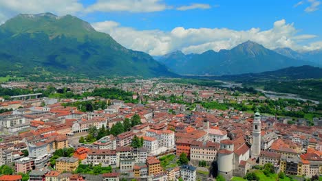 experience the beauty of belluno as the drone glides over its picturesque rooftops, revealing the intricate architecture and vibrant colors of this historic city