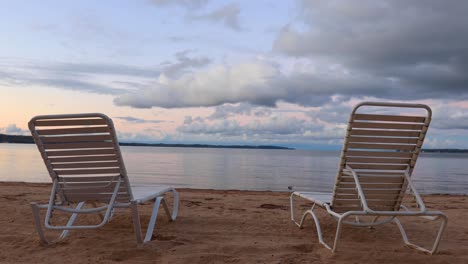 chairs at beach at sunset