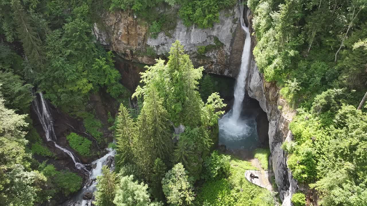 Cascata mozzafiato in una lussureggiante foresta montana verde.
