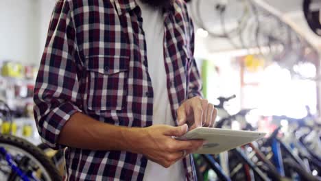 Mechanic-using-digital-tablet-in-workshop