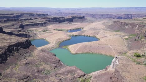 aerial rises over potholes coulee revealing ancient lakes far below