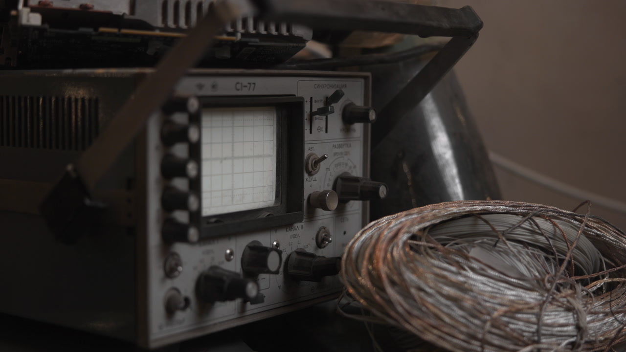 Signal Oscilloscope And Coiled Wire On Testing Bench, Glowing Trace And Control Knobs, Lab Repair Setting . Media