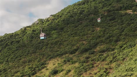 aerial drone view, cable cars or gondolas, trees and birds on mountain slope, salta, argentina