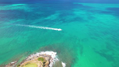 Aerial-drone-shot-of-boat-passing-by-st