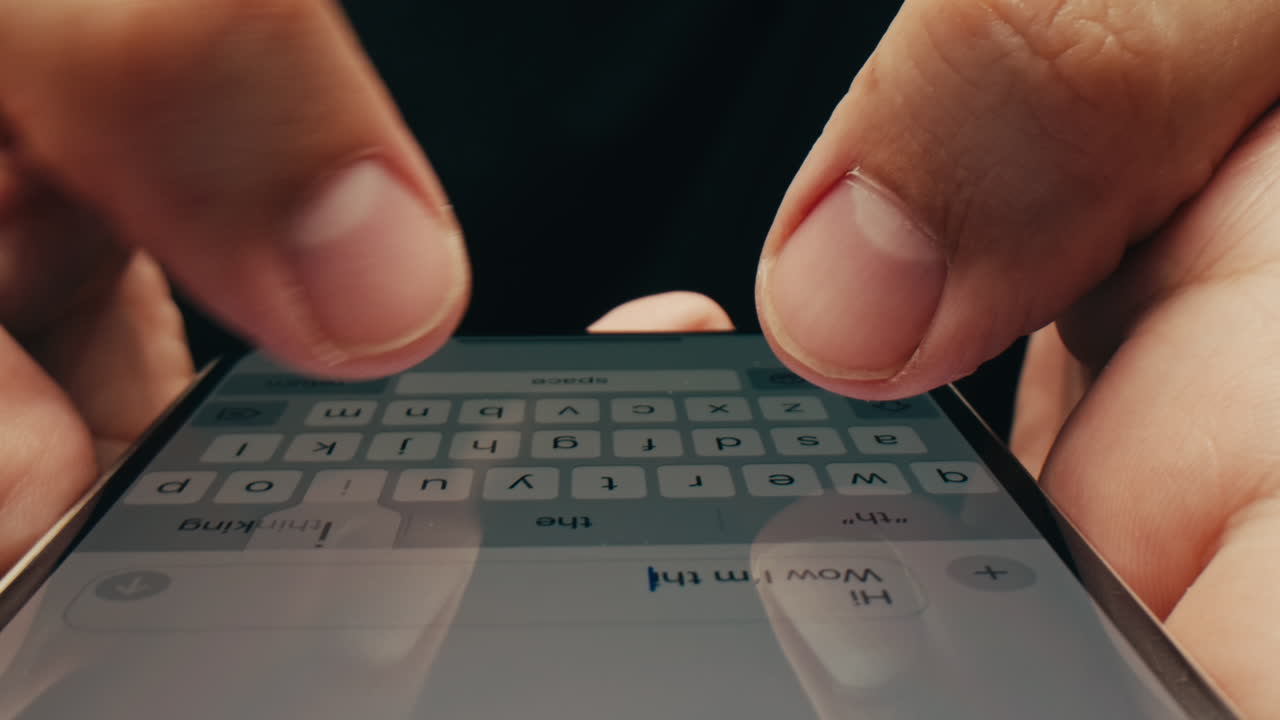 Hands typing on a smartphone