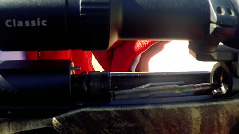 close-up-of-rifle-round-being-loaded-into-the-chamber-by-a-lady