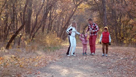 family walking in autumn forest