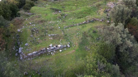 drone establishing of ancient thermopylae battlefield site and phocian wall ruins, green terrain