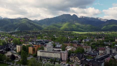 Sobrevuelo-De-Zakopane,-Polonia,-Un-Pueblo-Turístico-Con-Arquitectura-Goral-Tradicional-Cerca-De-Las-Montañas-Polacas-Tatra,-Tierras-De-Cultivo,-Bosques,-Pico-Giewont-Y-Gran-Salto-De-Esquí-Krokiew---4k-Rastreando-Hacia-Atrás-2