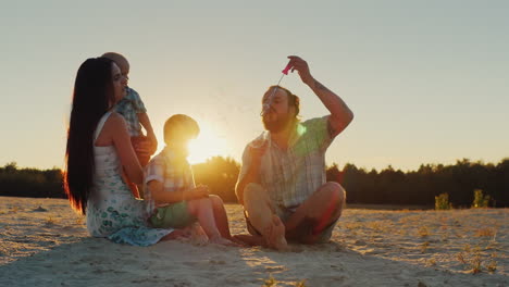 Happy-Family-Playing-With-Two-Kids---Blow-Bubbles