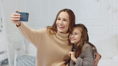 Retrato-De-Una-Familia-Riendo-Posando-Para-Un-Selfie-Móvil-En-Una-Casa-De-Lujo.